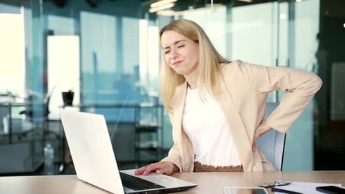 Woman in Office Experiences Back Pain
