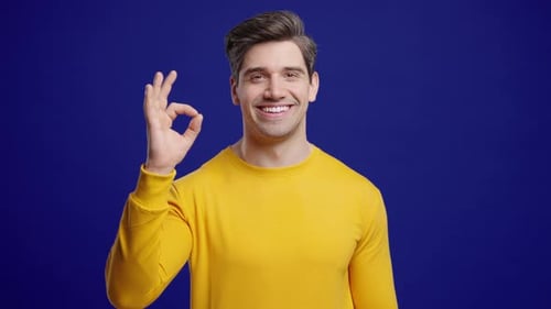 Positive Mature Man With Ok Okay Hand Sign Gesture Happy Man On Blue Studio