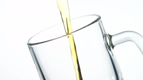 Pouring Delicious, Frothy Beer Into a Glass Mug