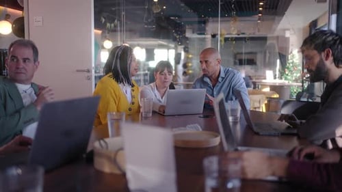Diverse Business Team Collaborating on Project in Modern Office