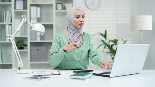 Woman in Hijab Working on Laptop in Office