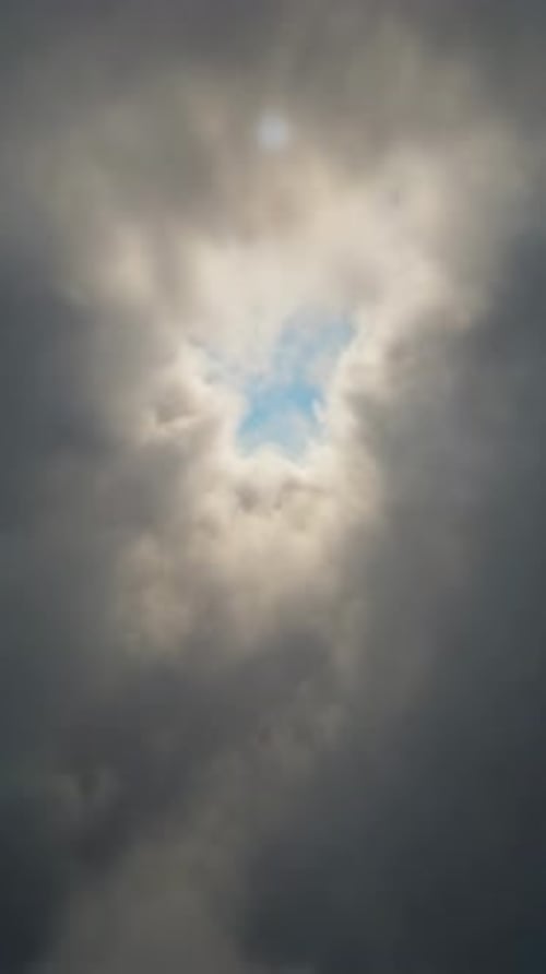 Cinematic Reveal Through Dark Clouds to Bright Sun