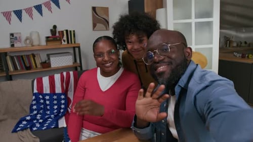 UGC of Family Smiling and Waving at Camera Recording Video for Social Media