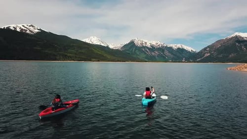 Aerial shot of two kayakers enjoying the stunning Colorado lake scenery