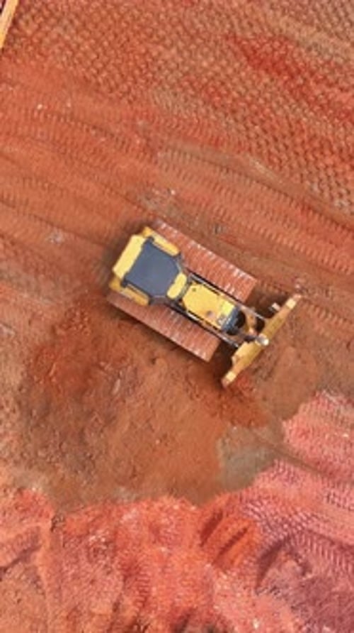 Heavy Machinery Working on a Construction Site for Land Grading During Daylight Hours