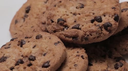 Close-up on Small Batch of Chocolate Chip Cookies Rotating, White Background