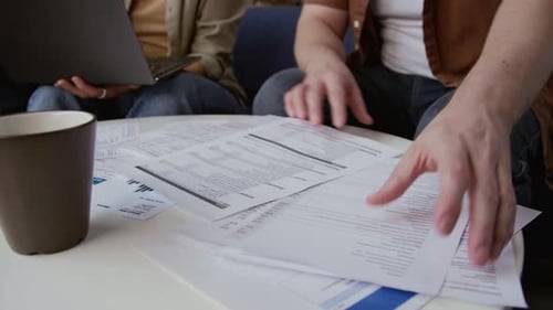 Couple Reviews Household Bills at Table