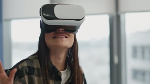 Happy Woman Watching Virtual Reality at Office