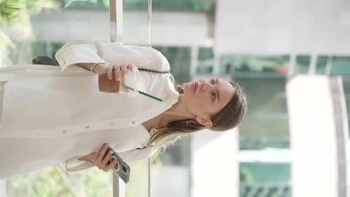 Woman on Phone With Coffee in City