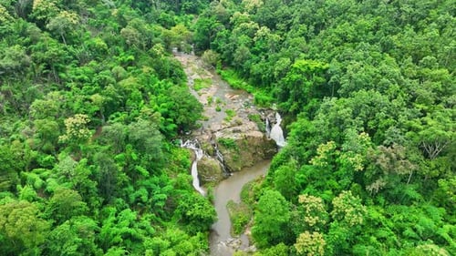 Aerial View of Tropical Waterfall in Green Forest