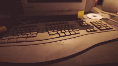A Close Up View of a Dusty Keyboard on a Vintage Desk with Soft Lighting