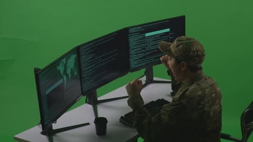 Asian Man Soldier Celebrating While Write Code With Multiple Computer Screens In Green Screen
