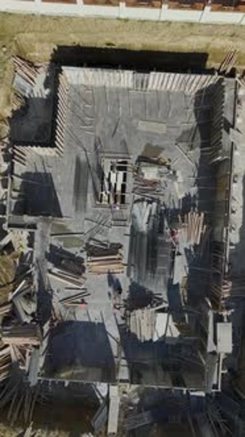 Vertical Video of Builders Raising Wall Frames on Site