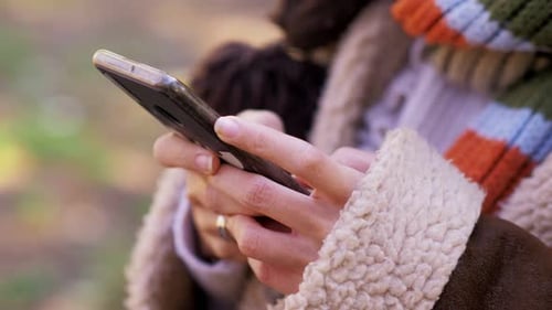 Woman Using Smartphone Device in Nature