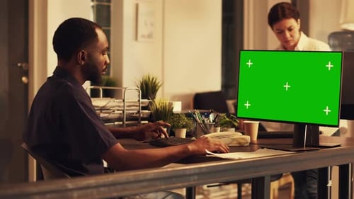 Man Works at Computer with Green Screen Monitor