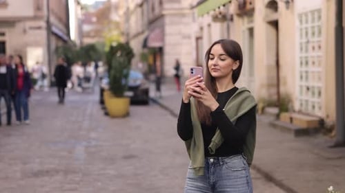 Young Woman Takes Photos in European City