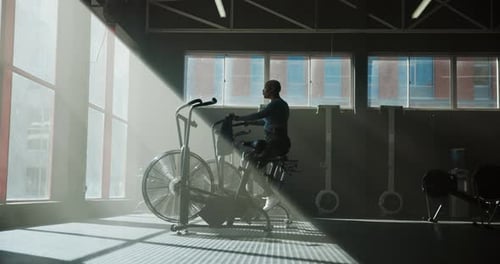 Stationary bike, workout and health with woman in gym for cardio, exercise machine and fitness