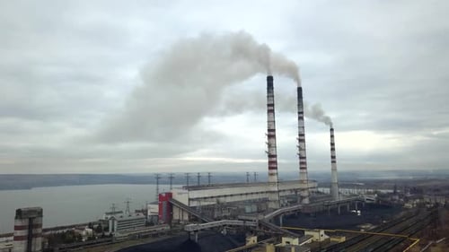 Aerial View of High Chimney Pipes with Grey Smoke From Coal Power Plant Production of Electricity