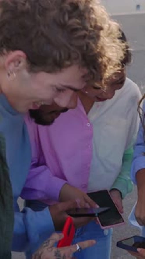 Group of Friends Laughing Looking at Their Phones