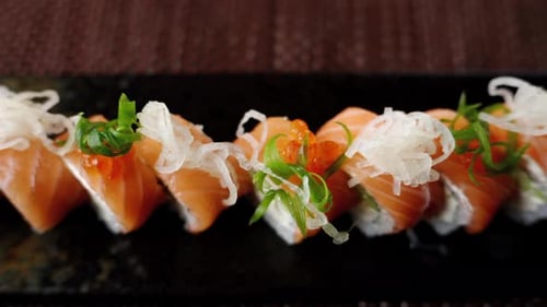 Close up of a Philadelphia sushi roll on a table at a restaurant