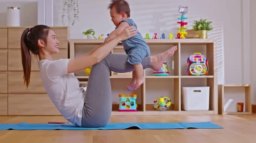 Mother Doing Ab Workout with Infant in Home