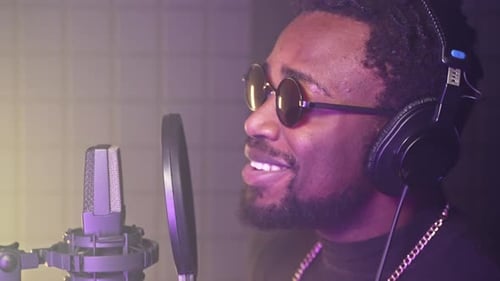 Musical Performer is Recording New Song in Record Studio Portrait of Black Man Near Microphone