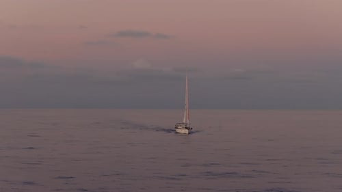 Majestic Sailboat Gliding Across Calm Ocean at Sunset