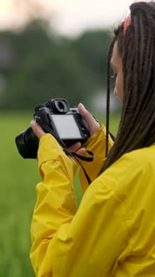 Young Woman in Yellow Jacket Photographs Nature