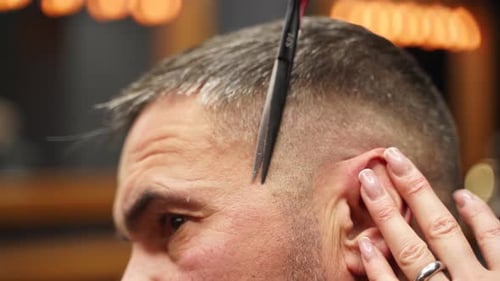 Attractive Barber Girl Cutting Man's Hair with Scissors and Comb Female Hair Cutter Working Serving