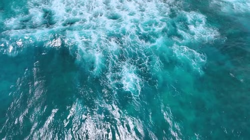 Turquoise water with foamy waves. Mesmerizing view of the waves rolling to the shore.