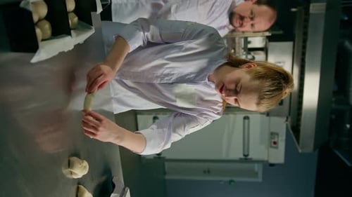 Woman Shaping Dough in a Commercial Kitchen