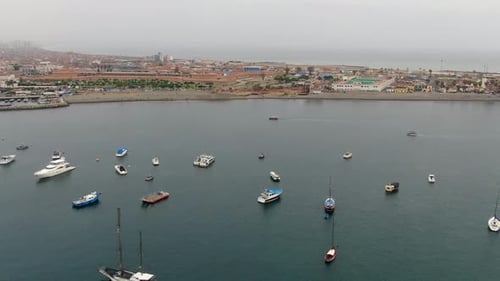 Drone shot of Callao district shoreline with parked boats and ships in Peru