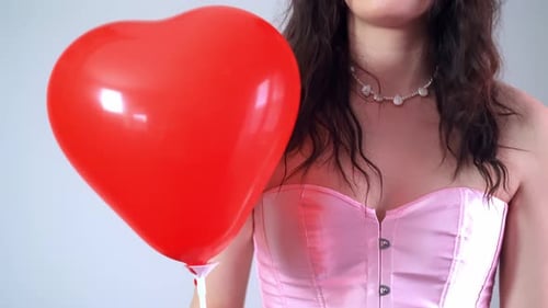 Woman Holding Red Heart Shaped Balloon