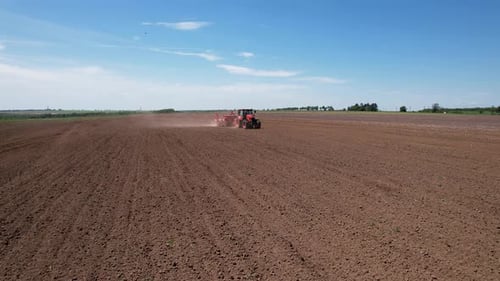 Aerial view of tractor plowing field, Bulgaria.