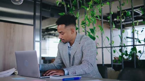 A Focused and Dedicated Professional is Engaging in Work Within a Contemporary Office Environment