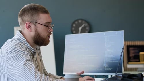 Man Working On Code In IT Office