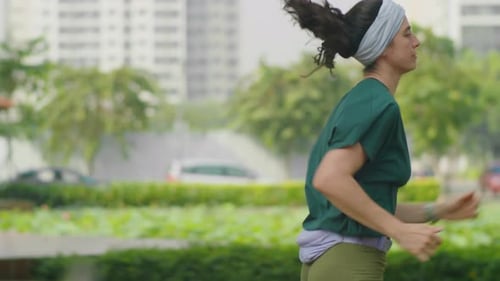 Athletic Woman Running Outdoors in City