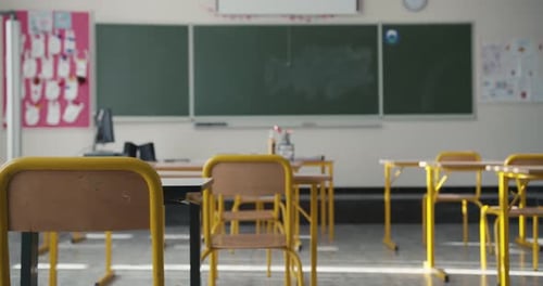 Empty Classroom with Yellow Desks and Sunlight