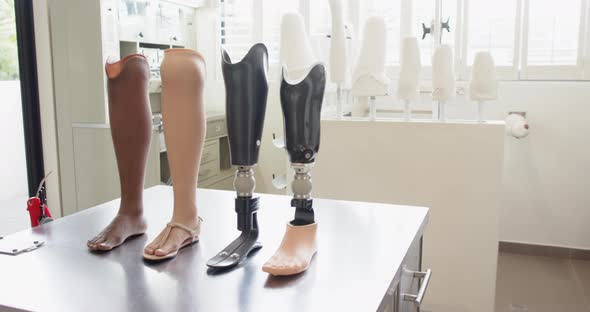 Prosthetic legs displayed on table in laboratory, showcasing different ...