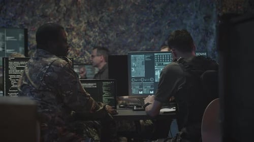 Military Cyber Security Workers Monitoring Data in Dark Office