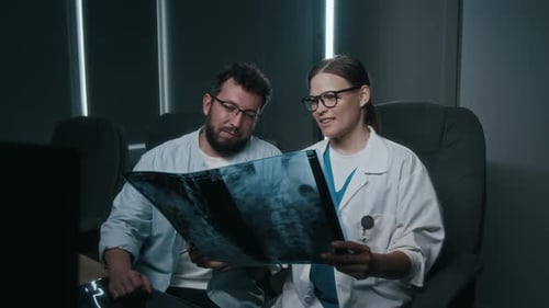 Doctors Review X-Ray in Hospital Office Setting