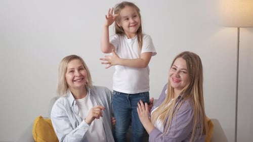 Happy Child with Women Smiling on Sofa