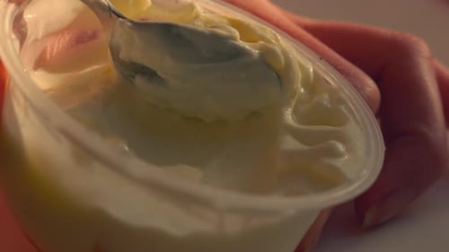 Spoon scooping Fresh Greek Yogurt in Natural Sunlight.