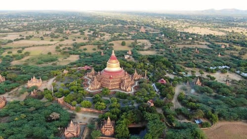 Ancient Buddhist temple in Bagan, Myanmar with more in background. Aerial shot.