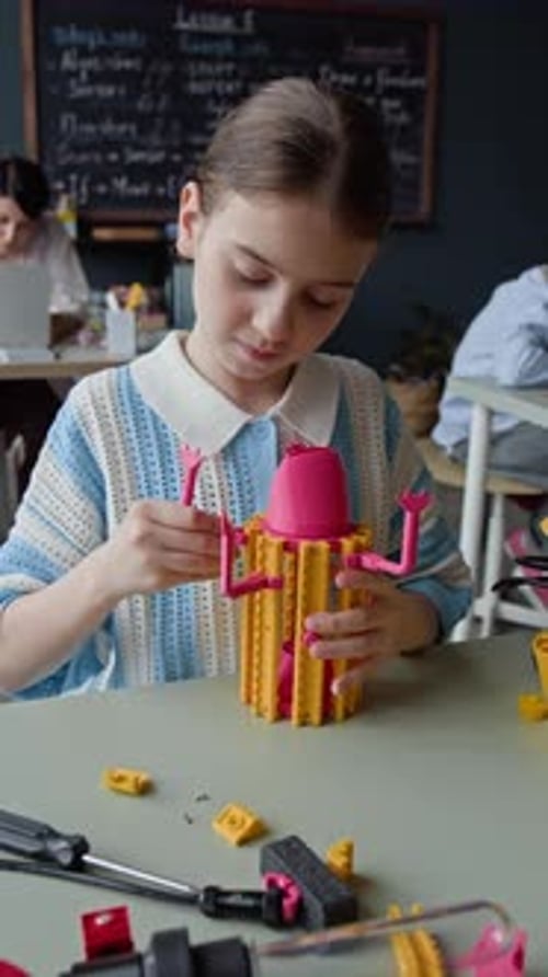 Schoolgirl Assembling Toy Robot in Elementary School Stem Class