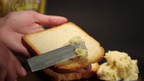 Spreading Creamy Spread on Toast for Breakfast