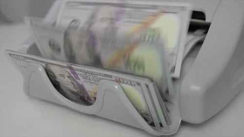 Side View of Machine Counting Money
