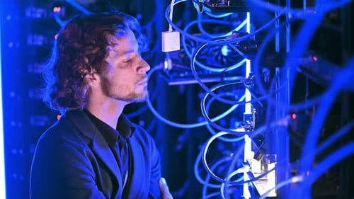 Man analysing servers in a data center