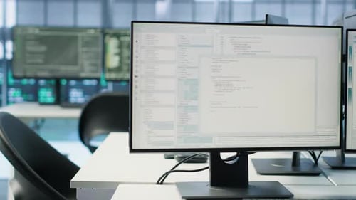 Close Up of PC Monitors on Desk Used for Monitoring Data Center Devices Energy