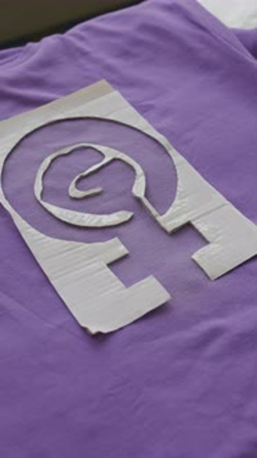 Close Up of Stencil on Purple Shirt